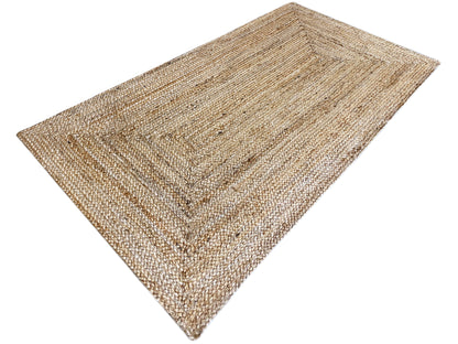 Rectangular jute rug, beige flat weave with a framed pattern and woven fringes