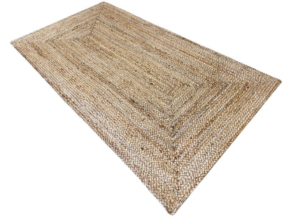 Jute rug in natural tones, rectangular, multicolored woven decorative pattern along the edges
