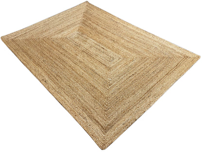 Rectangular natural jute rug with a square decorative pattern and visible woven texture