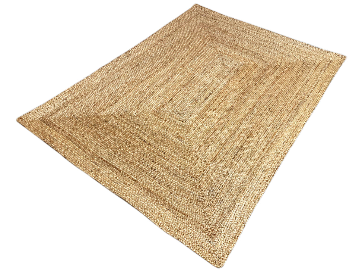 Natural jute rug, flat-woven, square pattern near the edge