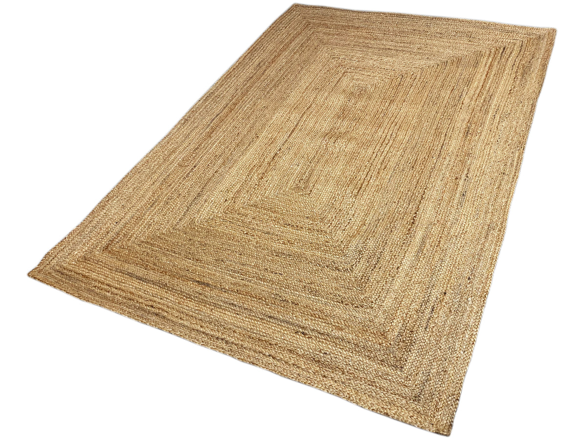 Jute rug 160x230 cm, positioned at an angle, rectangular border pattern in beige