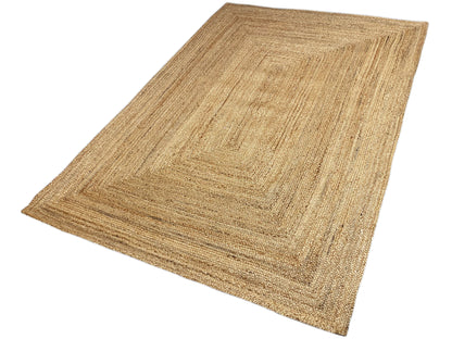 Jute rug 160x230 cm, positioned at an angle, rectangular border pattern in beige