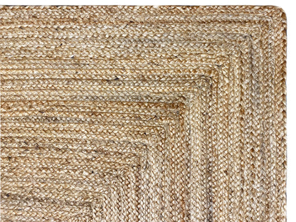 Jute rug: detail of the woven jute, beige thread pattern, and raised edge