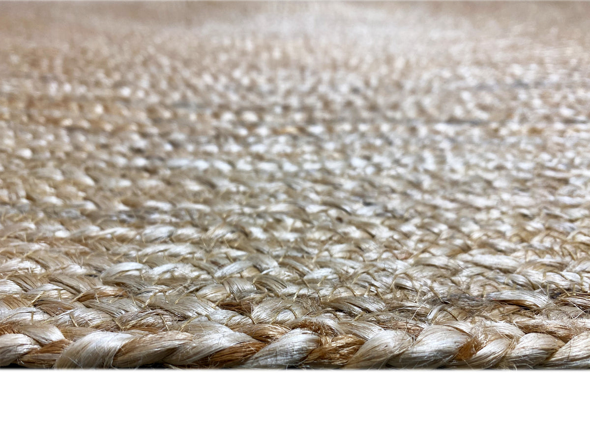 Close-up of a jute rug: woven fibers, natural-colored spiral texture