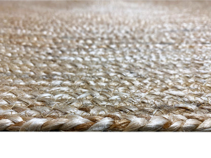 Close-up of a jute rug: woven fibers, natural-colored spiral texture