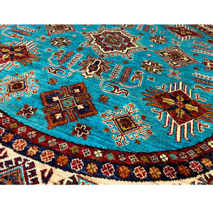 Close-up of a round rug: turquoise surface with multicolored animal and ornamental motifs
