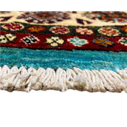 Close-up of carpet edge: turquoise pile with a white fringed trim