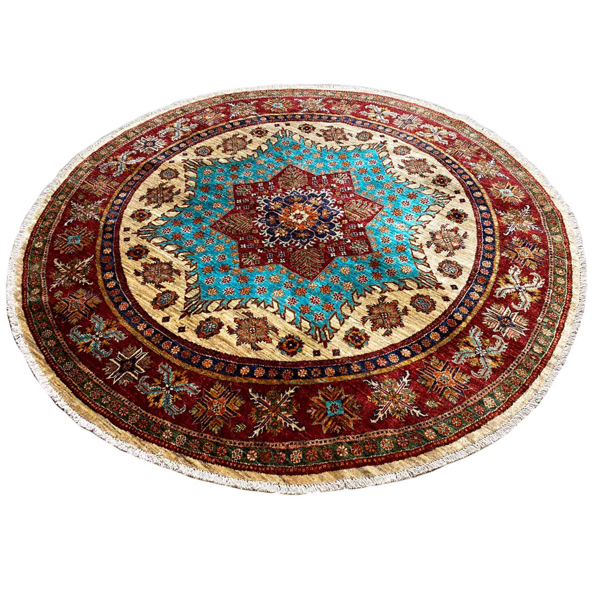 Round rug with a turquoise-red center motif, red medallion border, and fringe
