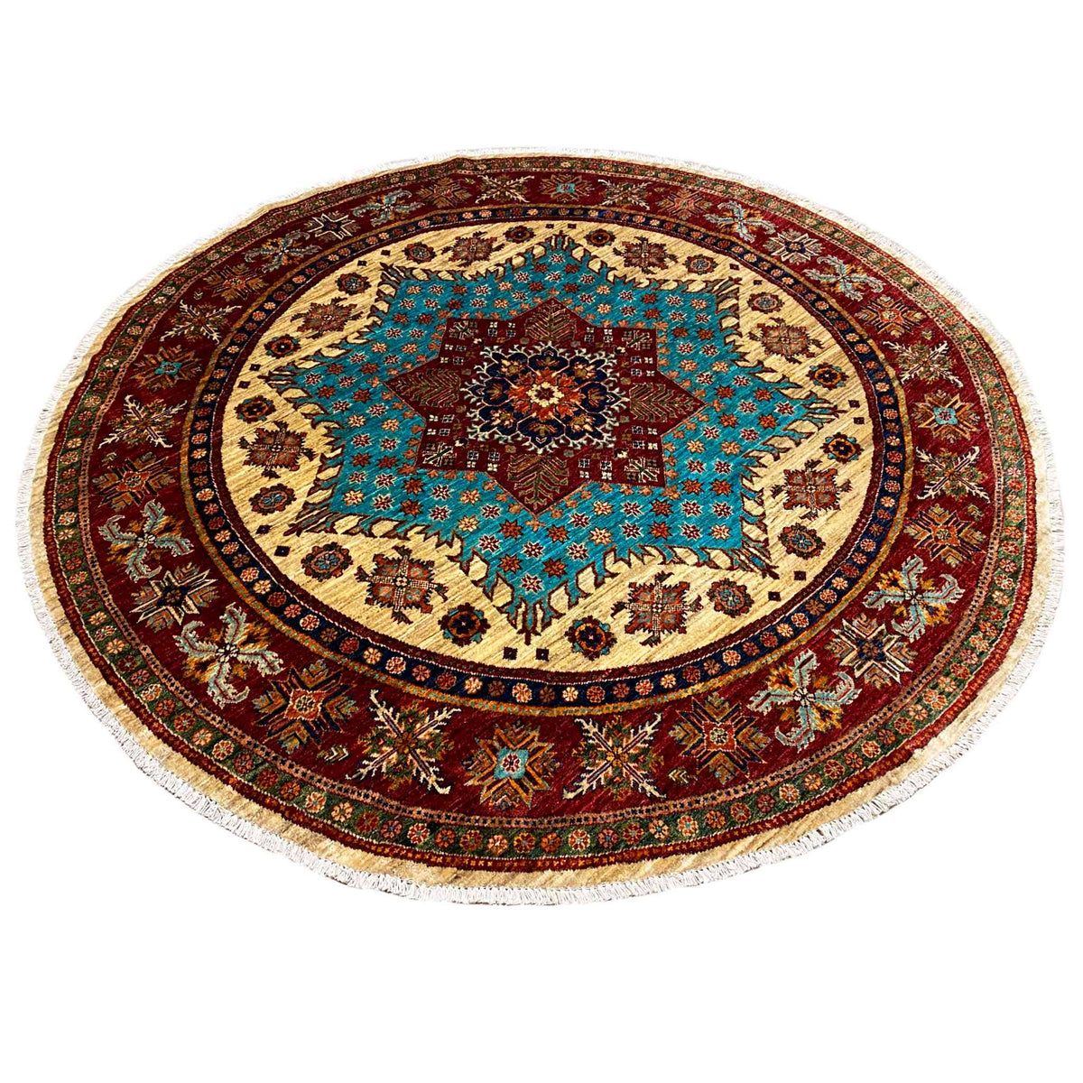 Round rug with a turquoise patterned star, red border, and fringe