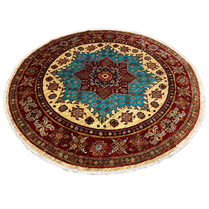 Round rug with a turquoise patterned star, red border, and fringe