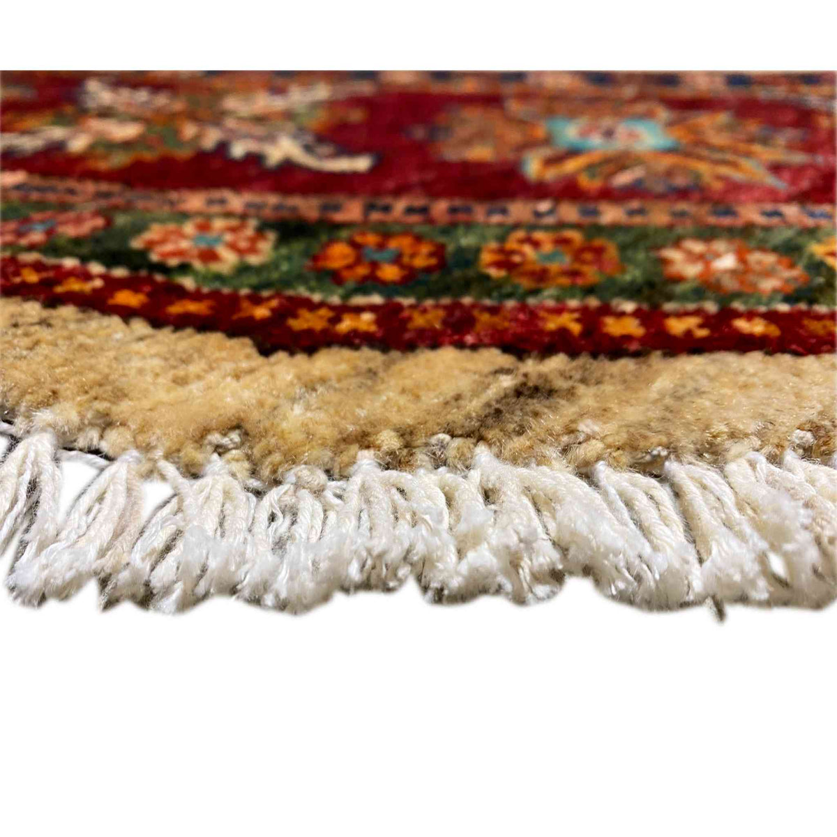 Rug edge with white fringe, with colorful borders underneath
