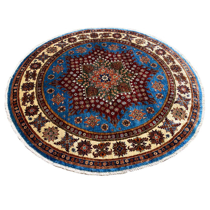 Round blue rug with a central ornamental star and intricately detailed raised design, multicolored