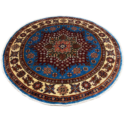 Round rug with a blue background, red central motif, and rich ornamental border