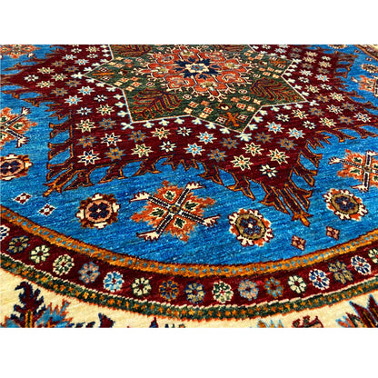 Close-up of the carpet pattern: blue field with red, green, and white ornaments
