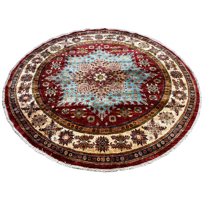 Round rug with blue ornamental inlay and decorative outer border