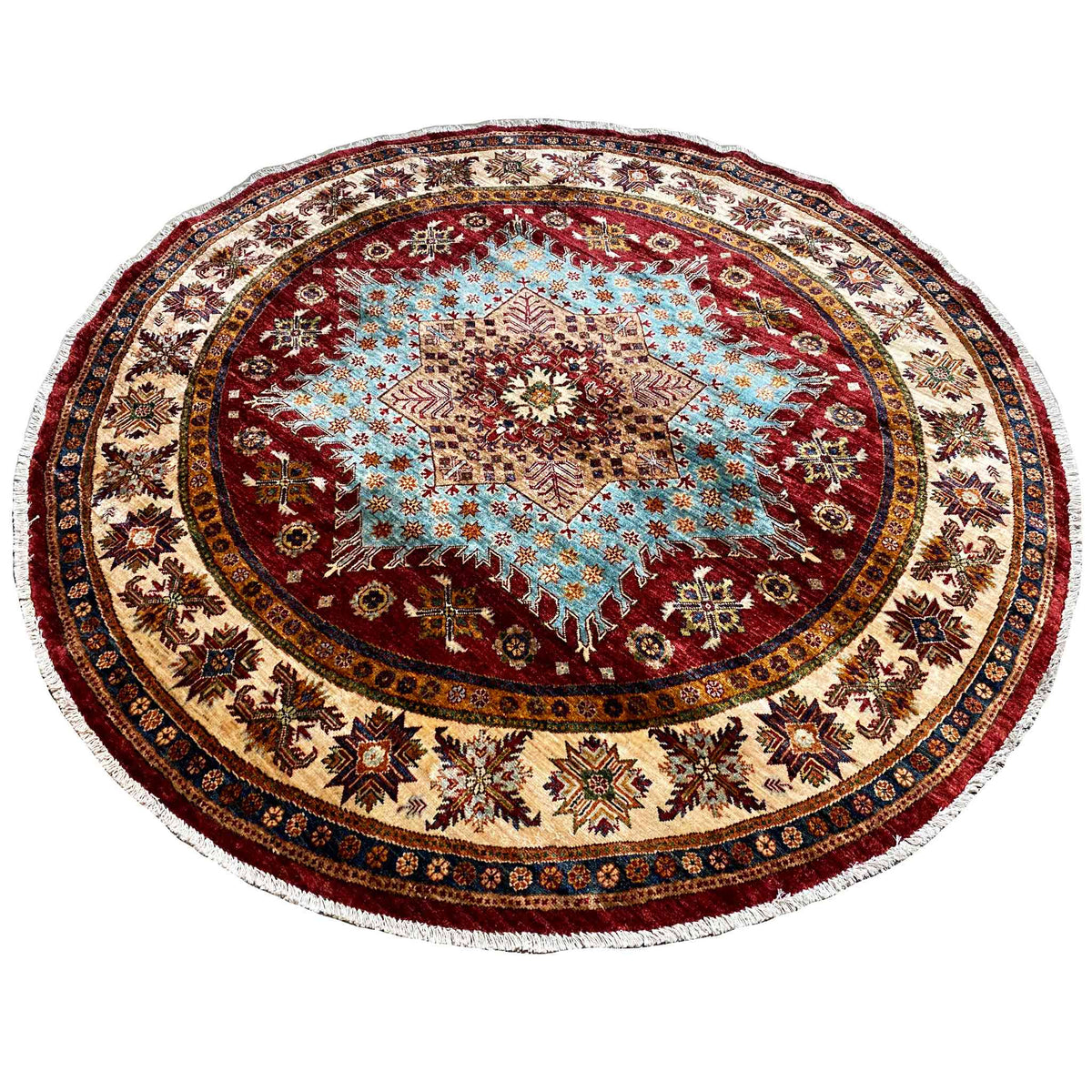 Round rug with a reddish-brown central motif and decorative border trim