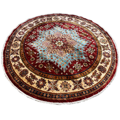 Round rug with a reddish-brown central motif and decorative border trim