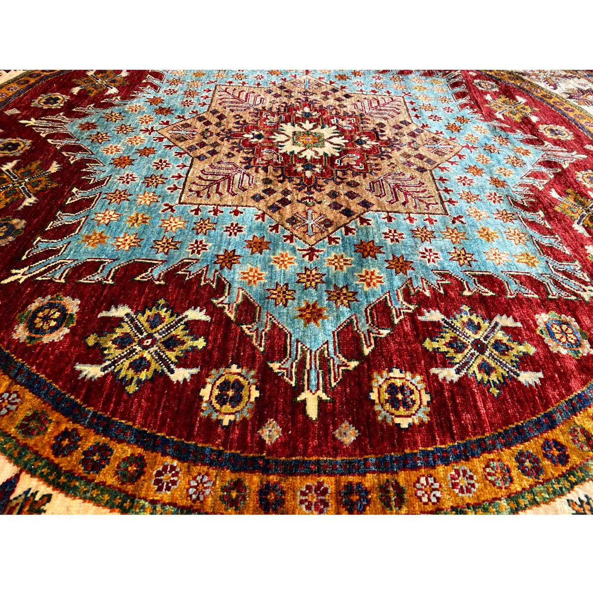 Close-up: Round rug with red, blue, and beige ornaments