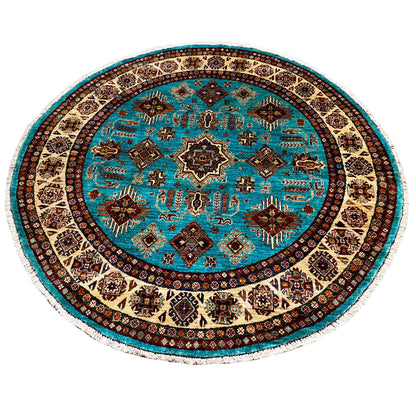 Round turquoise rug with a dark circular pattern and geometric border design