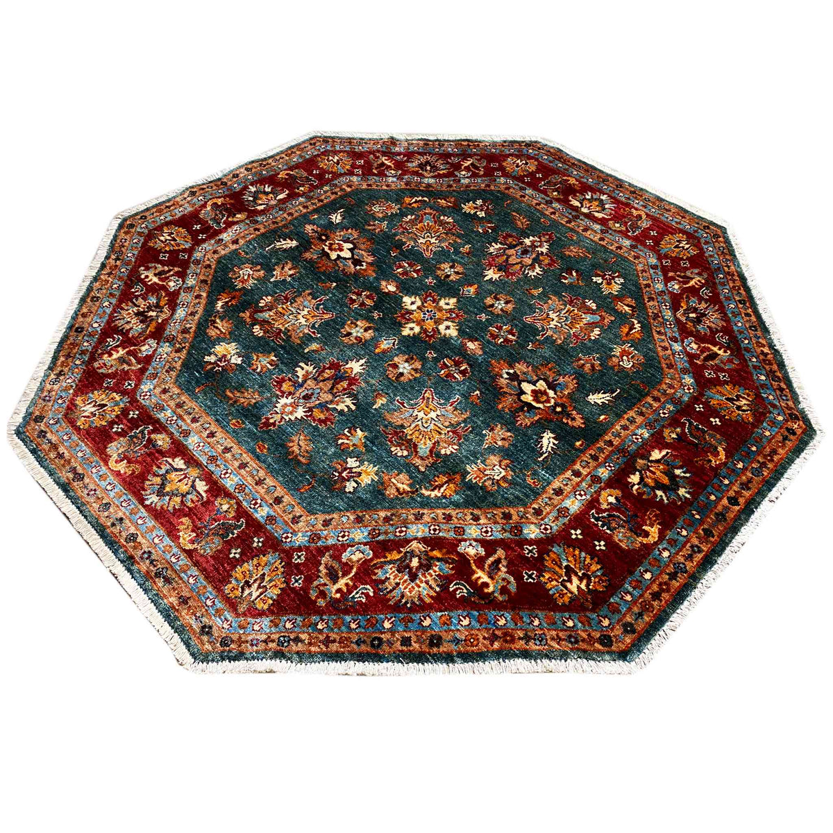 Octagonal rug with an intricate pattern in teal, red, beige, and gold
