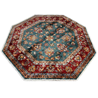 Octagonal rug with a decorative border and floral motifs in petrol blue