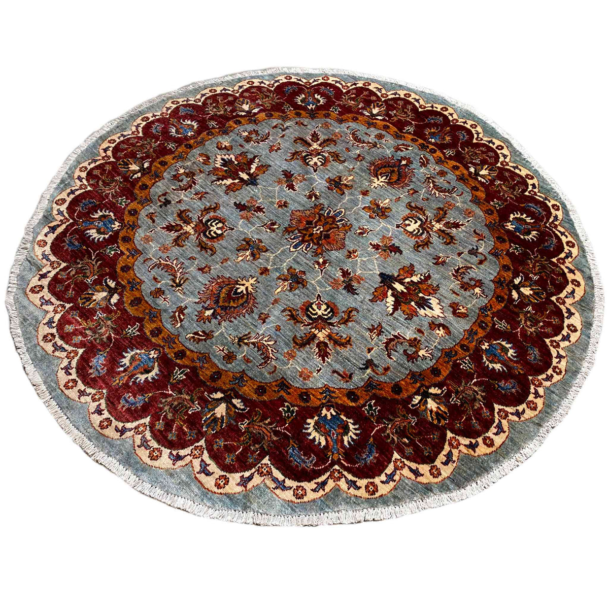 Round Kazak rug (176×175 cm) with a light blue base and contrasting, colorful ornaments.