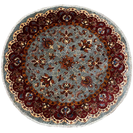 Round Kazak rug (176×175 cm) with light blue pile and a red ornamental border, colorfully embroidered.