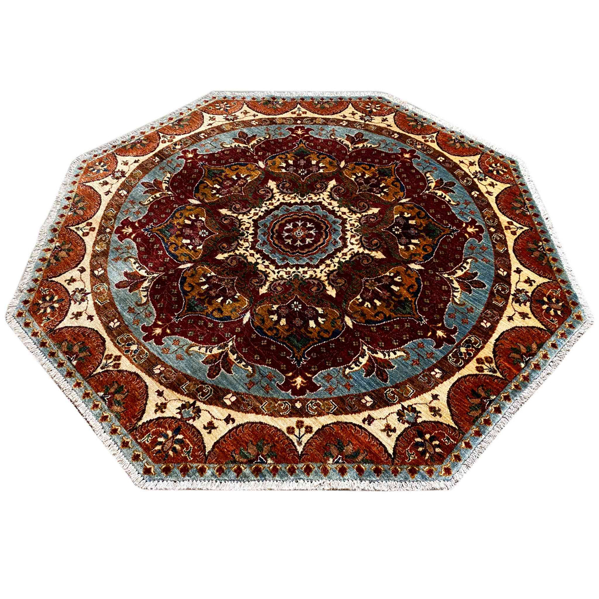 Octagonal rug with a round ornamental medallion, shades of blue and red, and a cream-colored border.