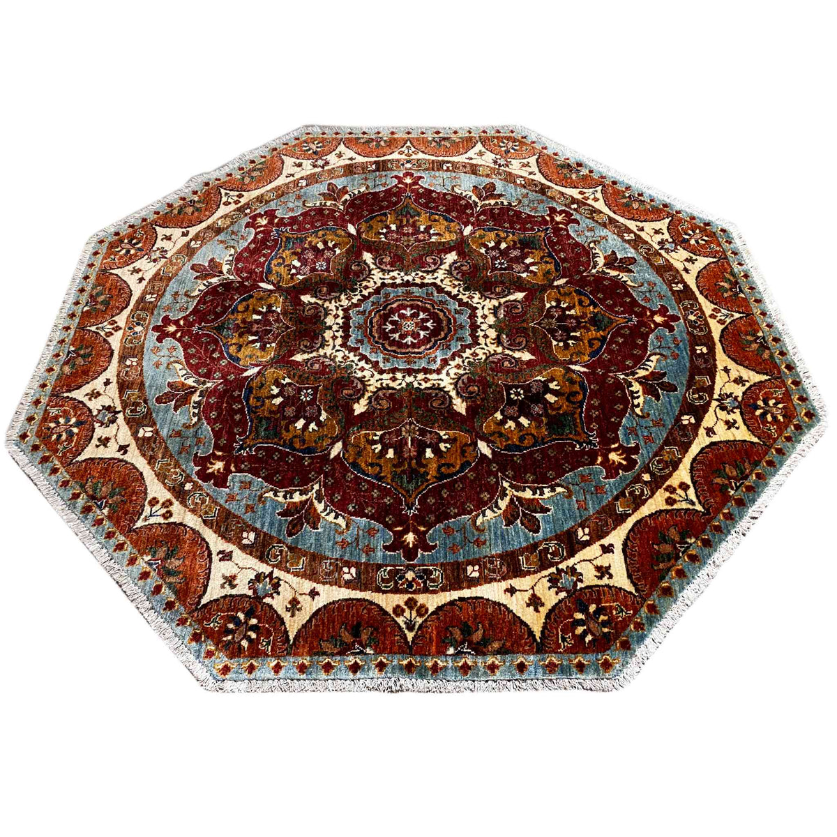 Octagonal rug with a dense paisley pattern and central rosette, red, blue and beige.