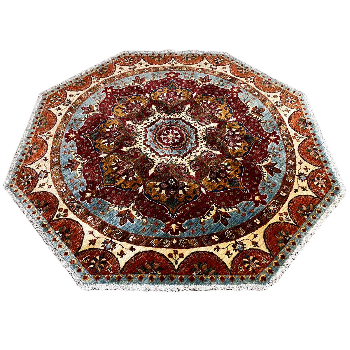 Octagonal rug with a symmetrical ornamental border and central rosette, in red and blue tones.