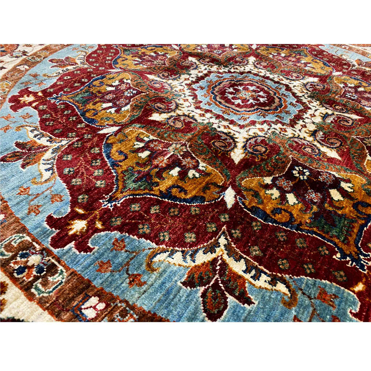 Octagonal rug: detailed view of the colorful ornamental pattern in red, blue, and beige.
