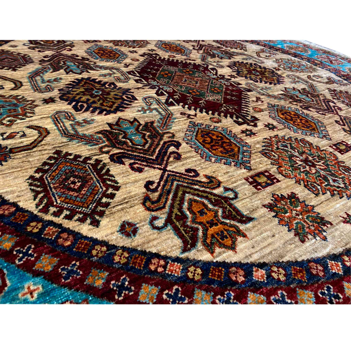 Close-up of the carpet: cream-colored pile with colorful geometric patterns