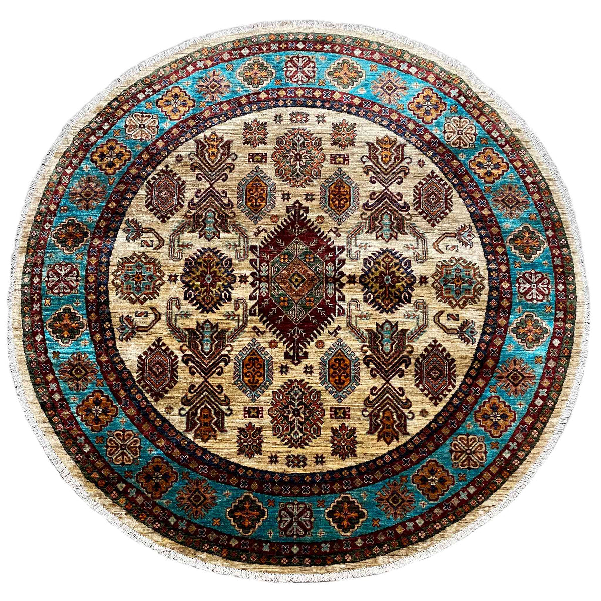 Round rug with a geometric pattern in cream, blue, and brown, with a fringed edge