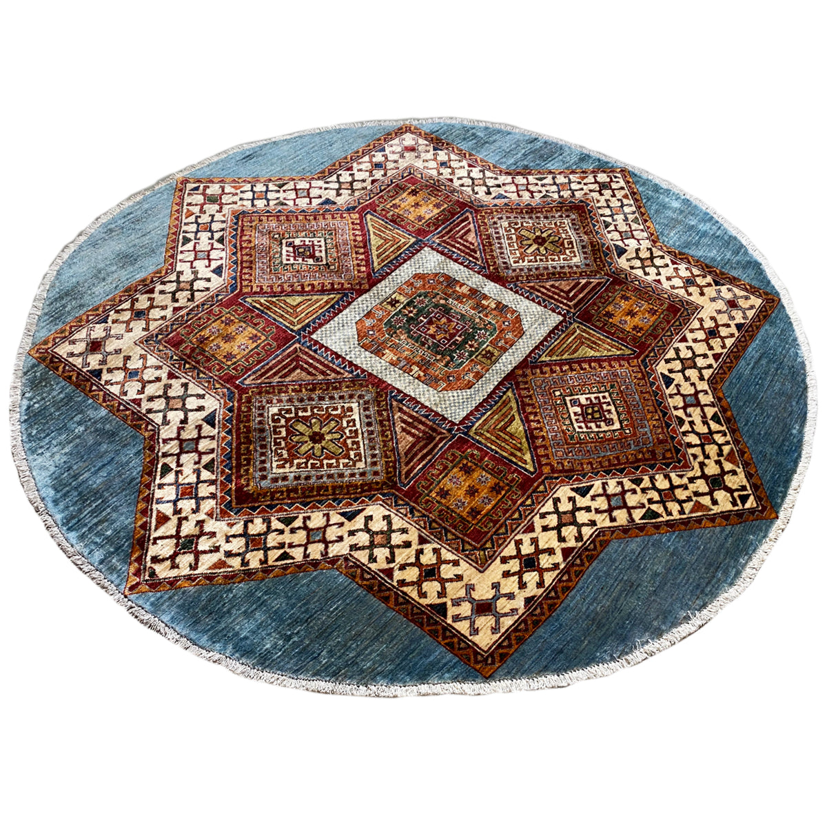 Round Kazakh rug with a large star pattern, blue border, and colorful diamonds
