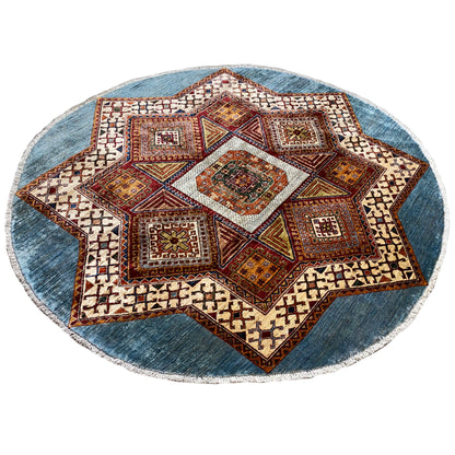 Round Kazakh rug with a large star pattern, blue border, and colorful diamonds
