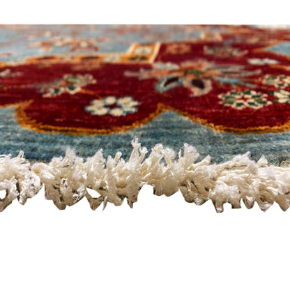 Rug edge with a high pile and frayed tassels, blue and burgundy patterns