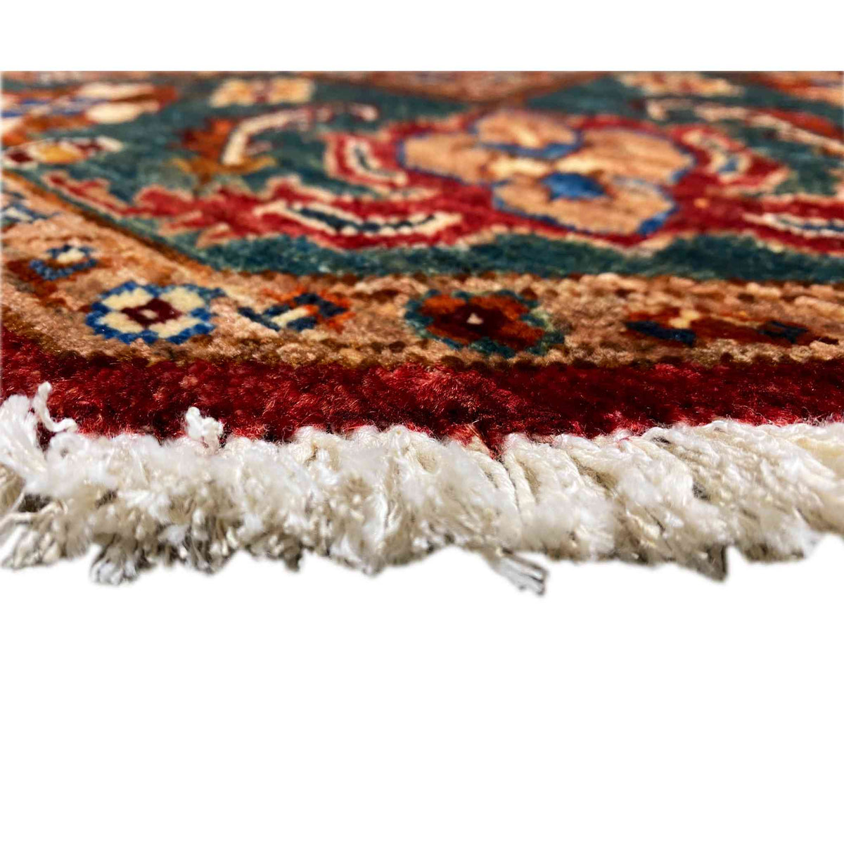 Rug edge with fringe trim, multicolored woven texture, and red background