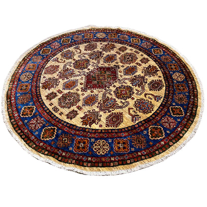 Round rug with an intricate pattern in blue, red, and brown on a light background