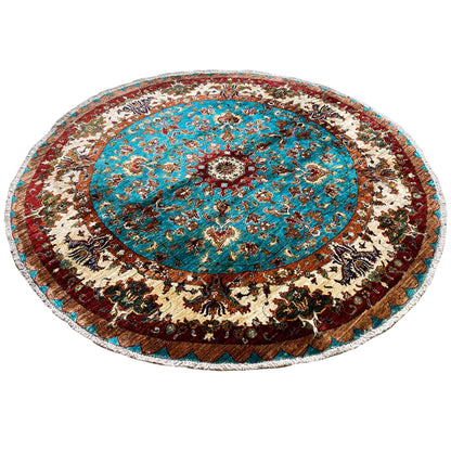 Round rug with a turquoise center, beige decorations, and a dark border