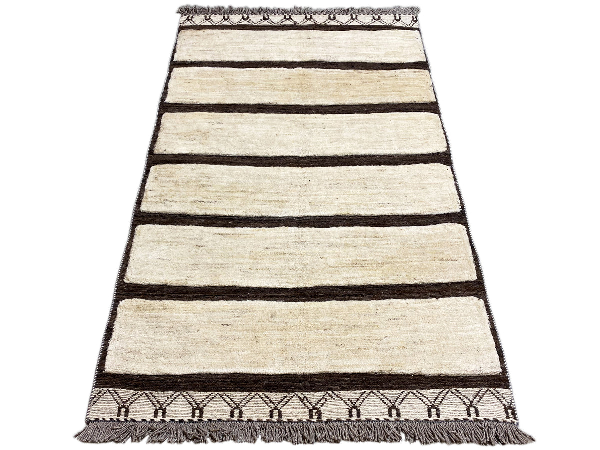 Rectangular rug with horizontal cream-colored stripes and a dark border, fringes