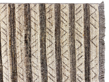 Close-up of kilim rug: diagonal and vertical stripes in beige, gray, and dark brown