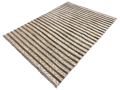 Kelim Gabbeh rug at an angle, elongated stripes in beige and dark brown