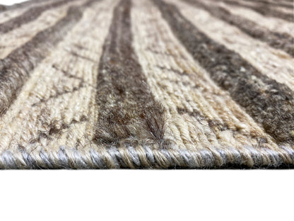 Surface detail of a kilim rug with pile and dark beige lines in a striped pattern