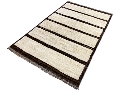 Kilim rug with elongated stripes in beige and dark brown, rectangular shape, fringes at the corners.