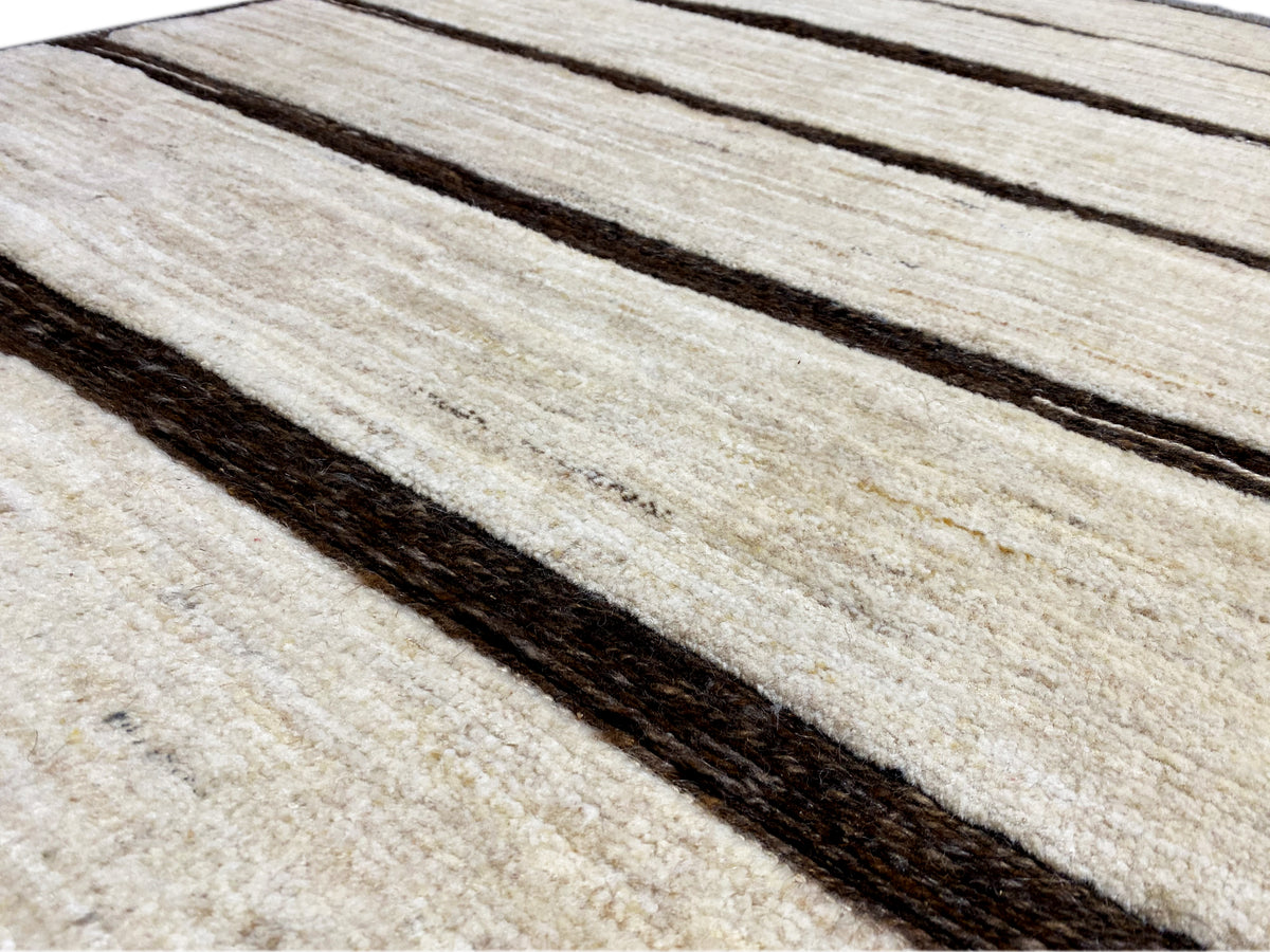 Detailed view of the kilim: light beige stripes with dark lines and a visible texture.
