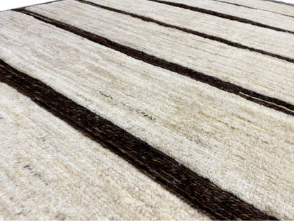 Detailed view of the kilim: light beige stripes with dark lines and a visible texture.