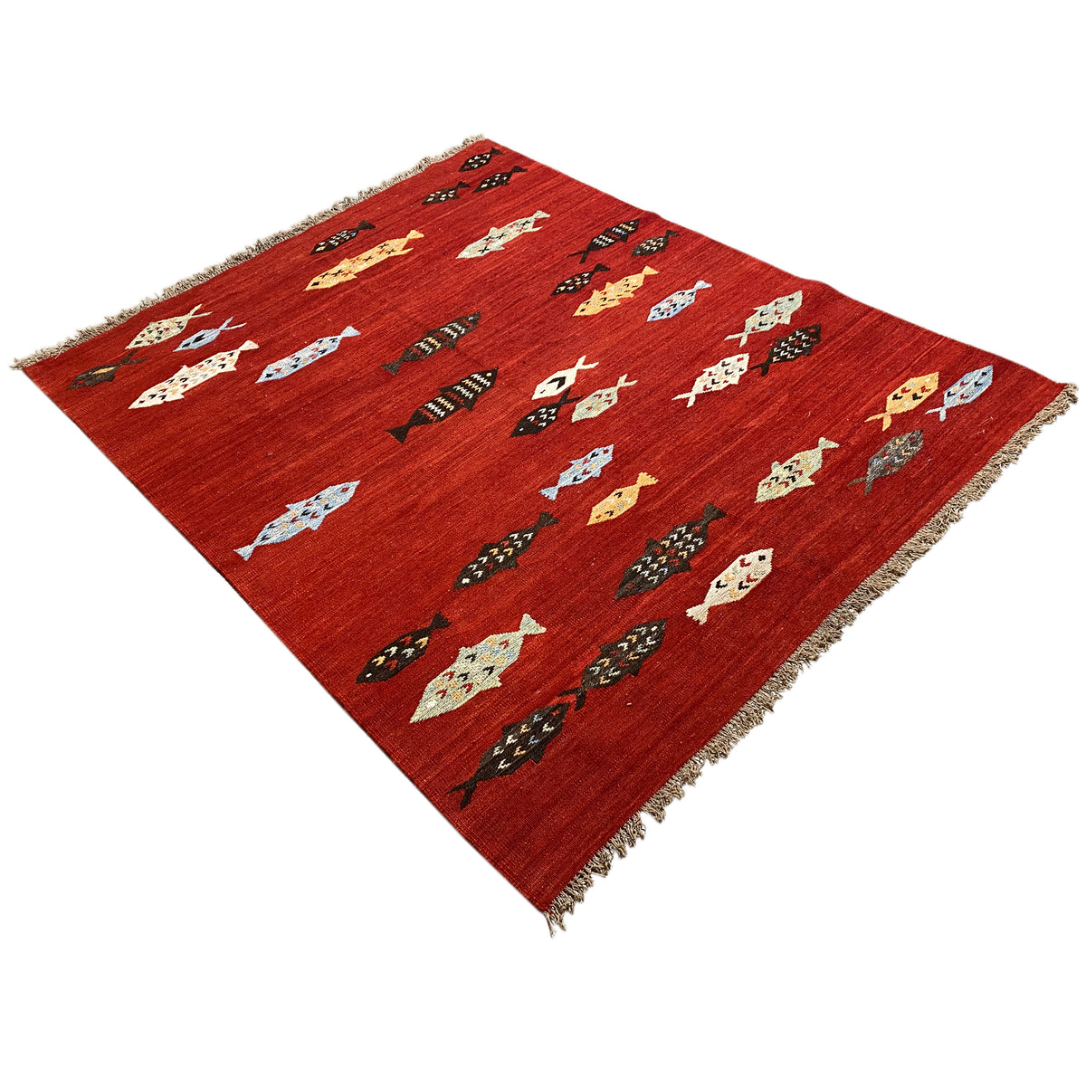 Red kilim rug with geometric animal and cross motifs, resembling embroidery, fringes