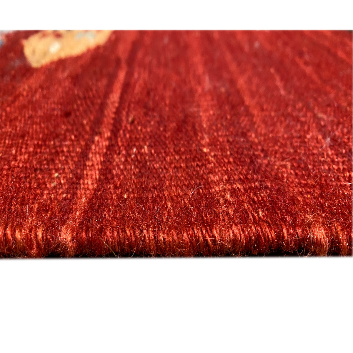 Detailed view of the rug edge: red kilim with fringes and woven texture