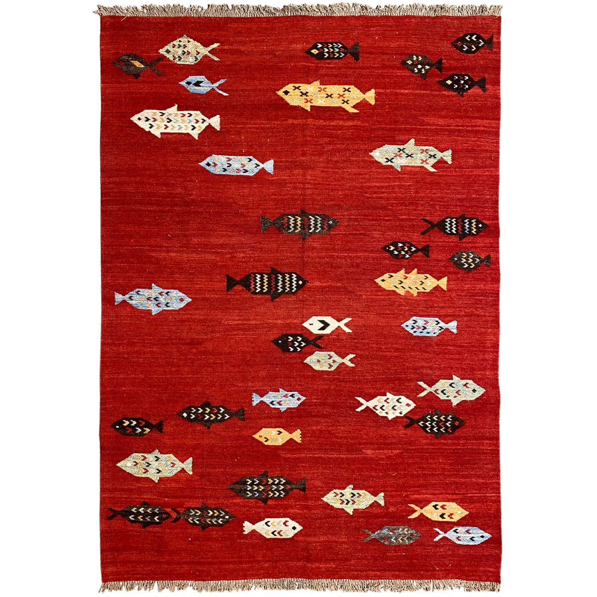 Red kilim rug with patterned motifs and fringes, flat-woven