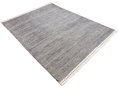 Woven rug, dark gray patterned, with border and dotted decorative stitching
